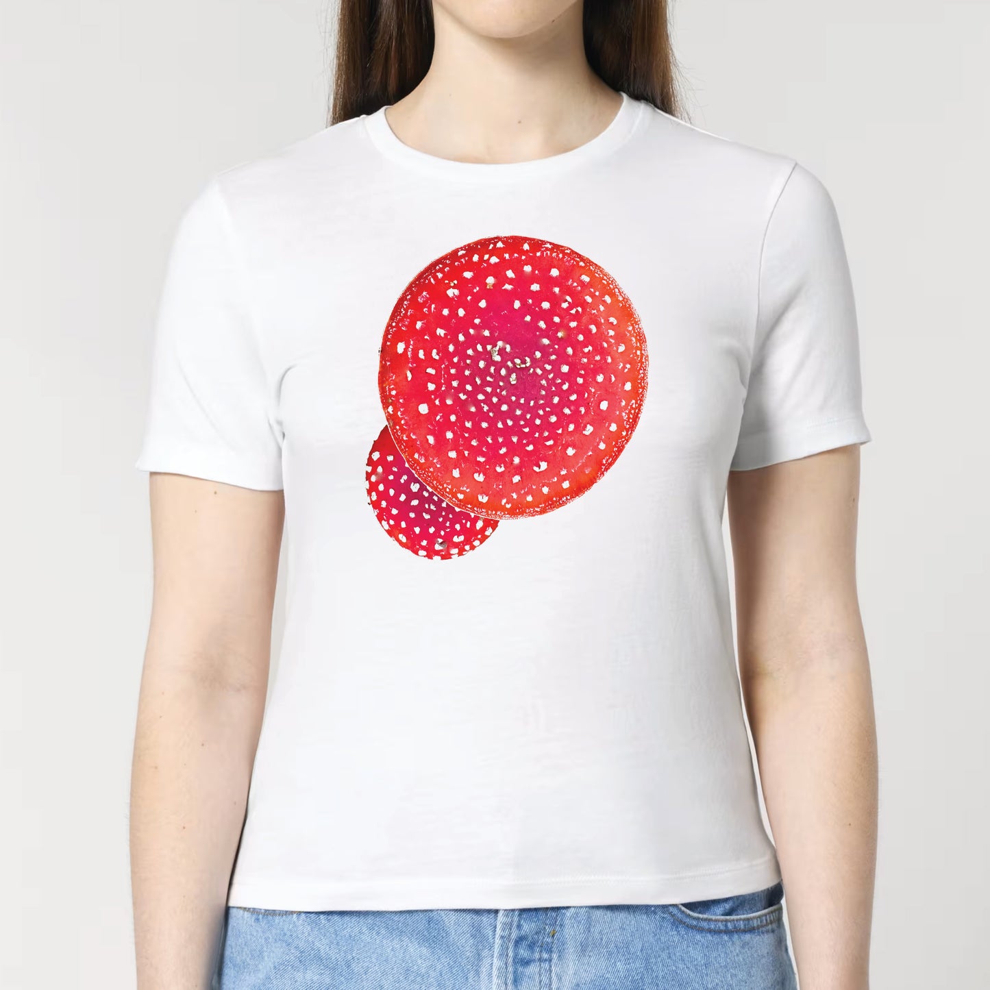 Woman wearing a white t-shirt with red white spotted red mushrooms